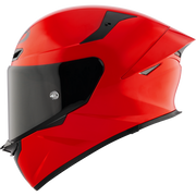 Red motorcycle helmet with a black visor on a white background