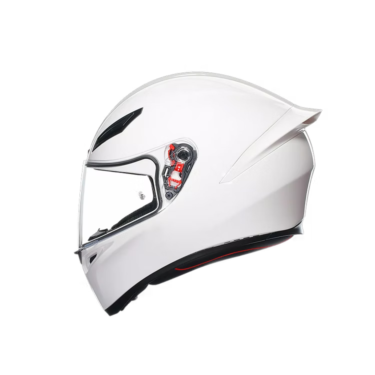 White motorcycle helmet with clear visor on a white background