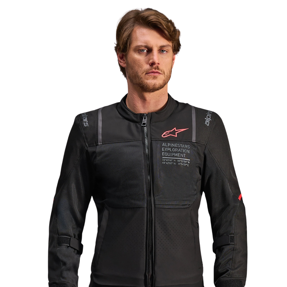 A man wearing a black Alpinestars Exosuit Jacket against a solid white background.
