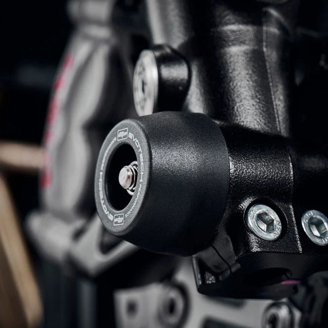 CNC machined Evotech spindle bobbins installed on Street Triple 765 RS front wheel