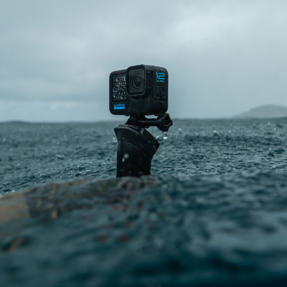 Action camera on a tripod over water with a stormy sky