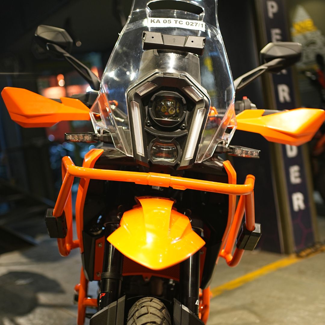 Side-mounted orange crash guard designed for KTM 250/390 models