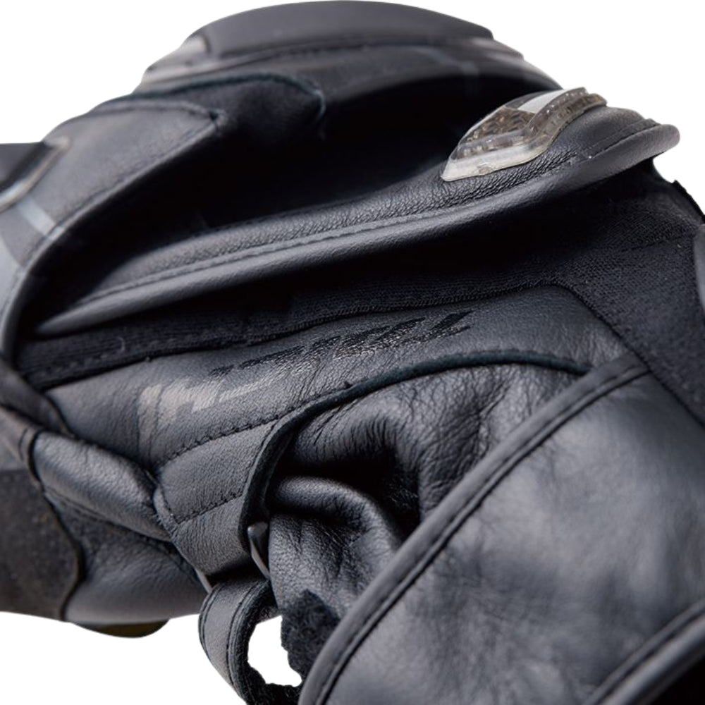 Close-up of a black leather glove with a brand logo on a white background