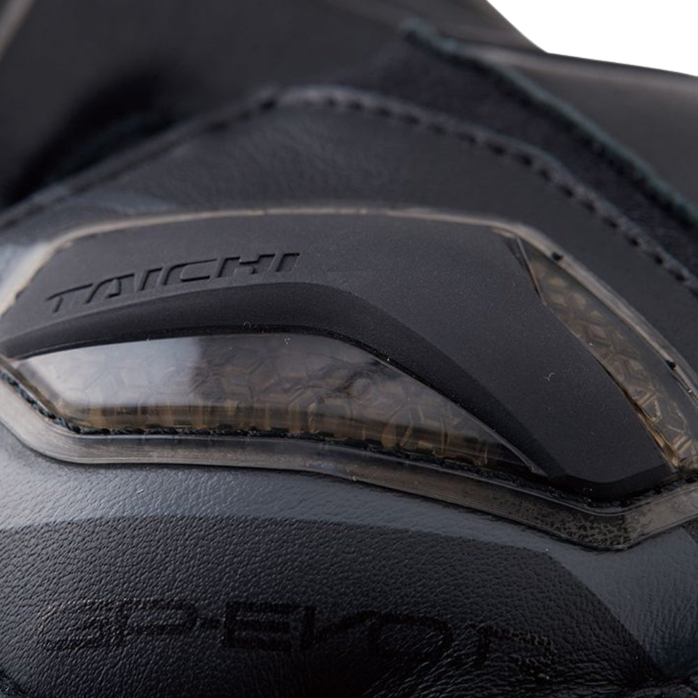 Close-up of a black motorcycle glove with 'Techi' branding on a white background