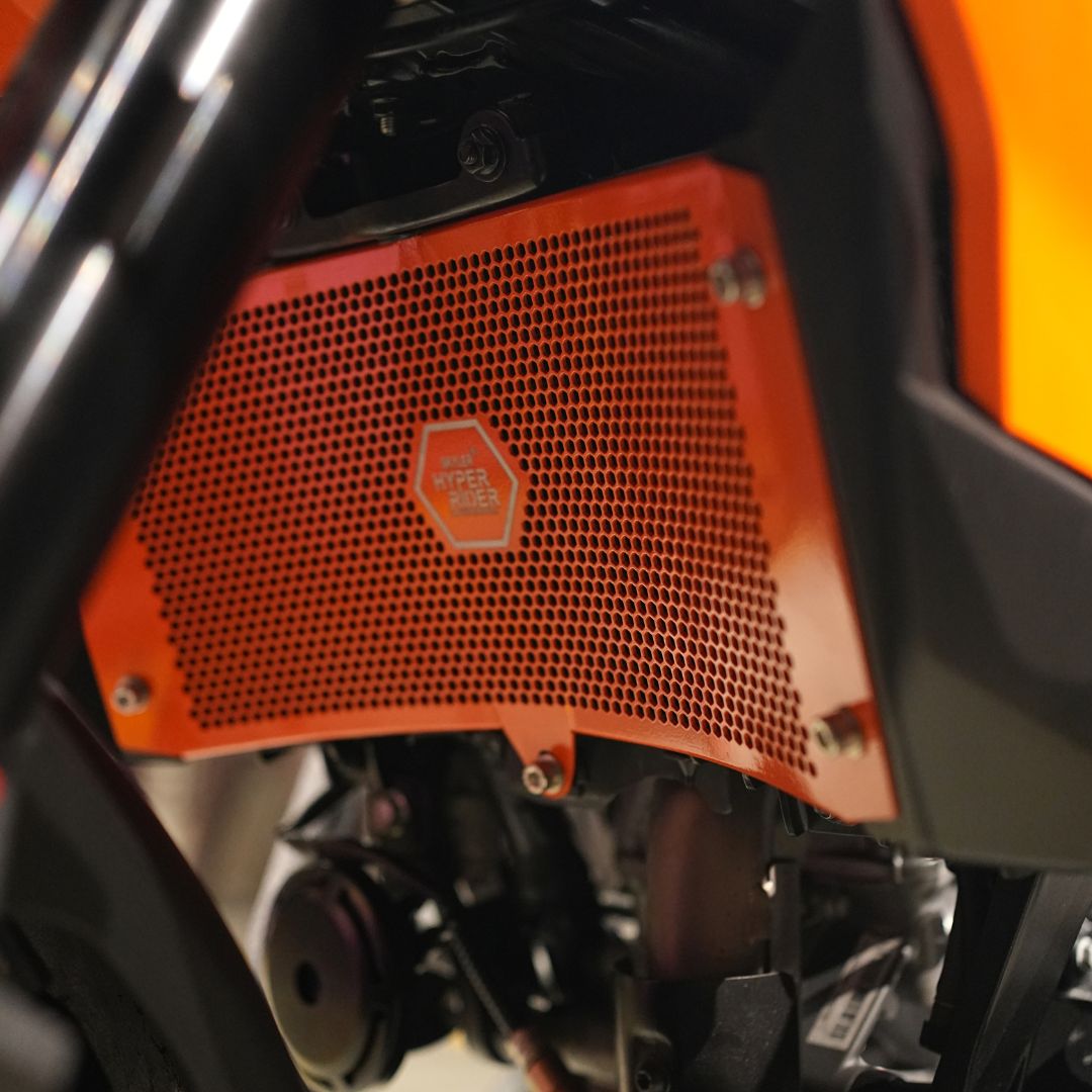 Close-up of bright orange radiator guard protecting KTM ADV 390 X radiator