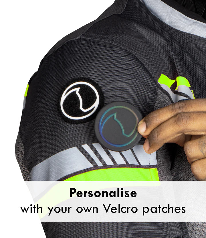 Person holding a Velcro patch on a jacket with text 'Personalise with your own Velcro patches'. - Grey Hi-Viz Green