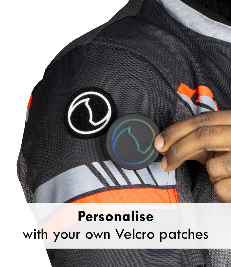 Person holding a Velcro patch on a black and orange jacket with text 'Personalise with your own Velcro patches'. - Grey Hi-Viz Orange